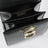 Small black leather top-handle bag with Gancini closure