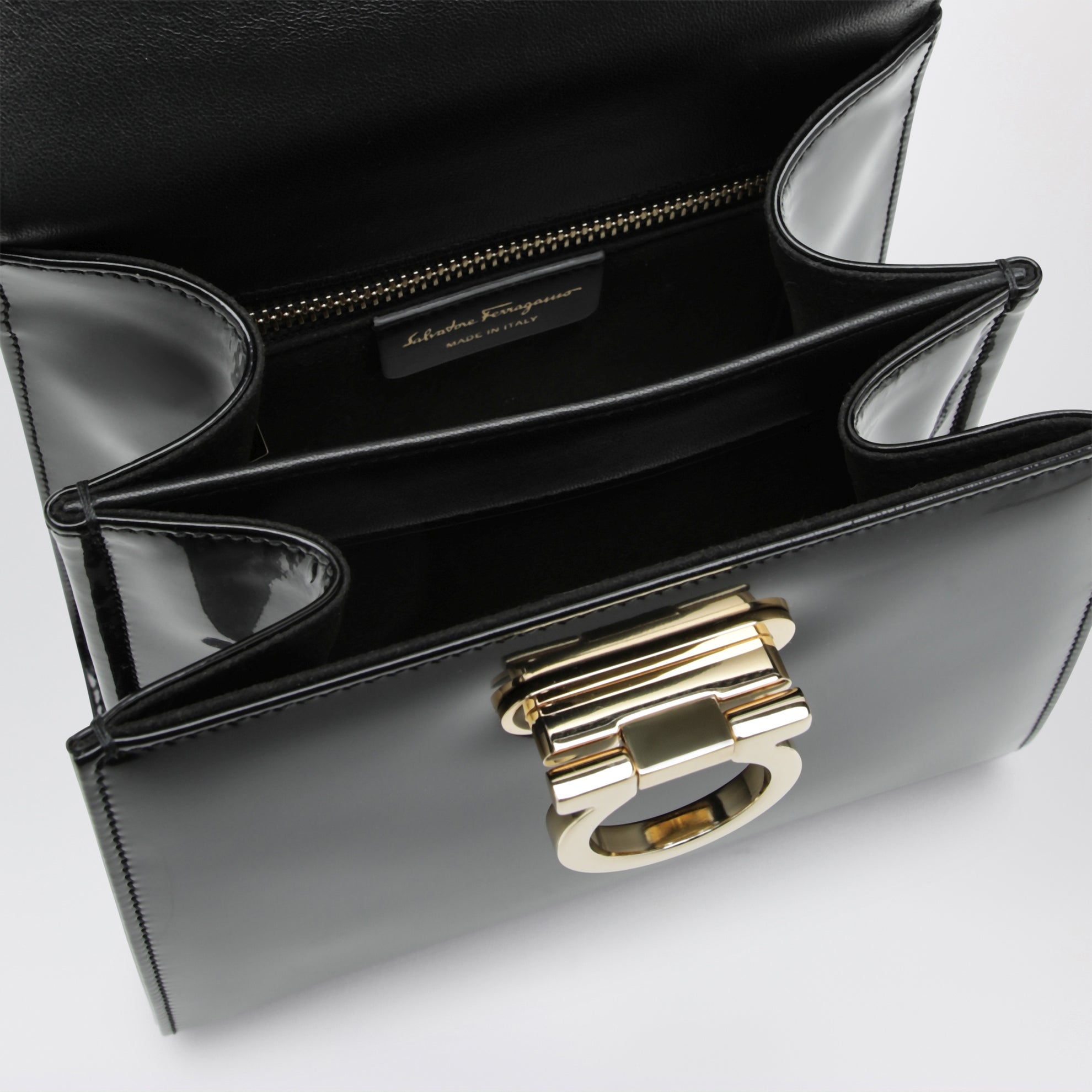 Small black leather top-handle bag with Gancini closure