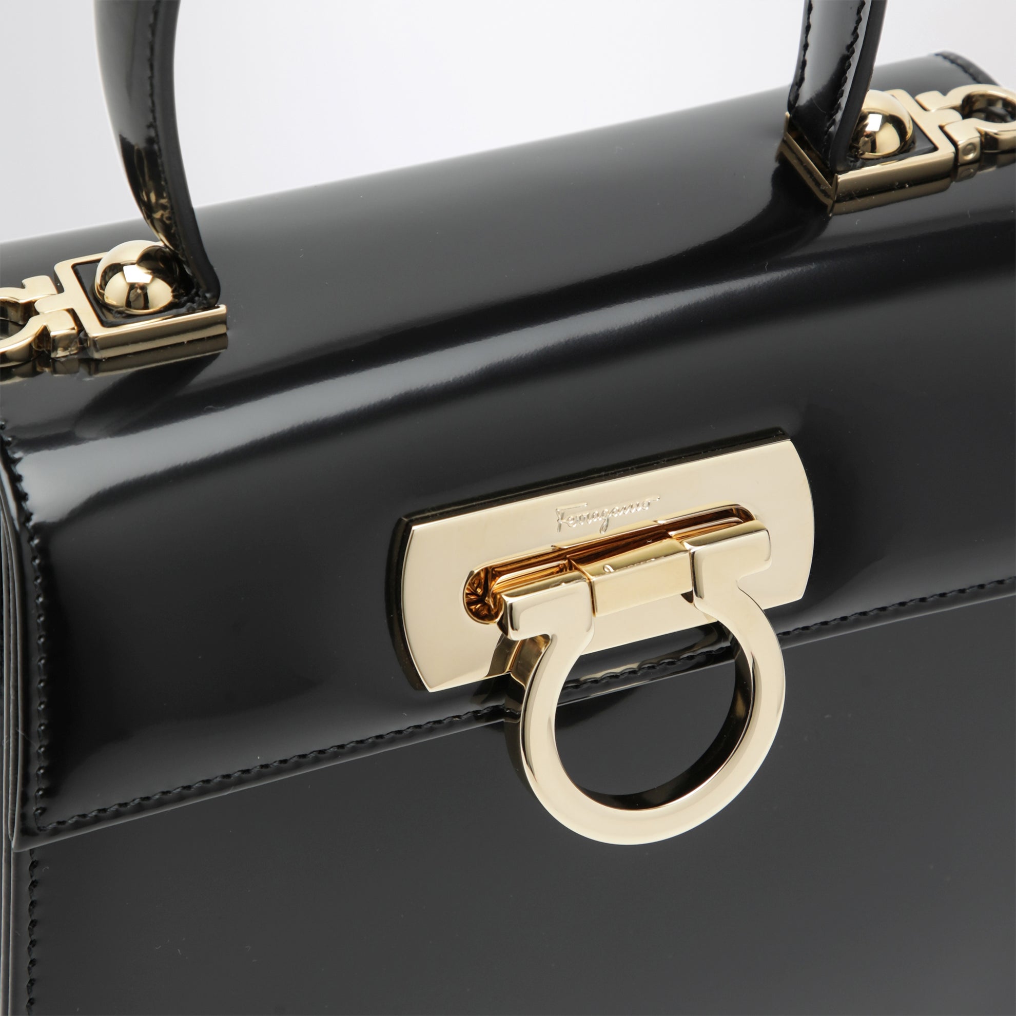 Small black leather top-handle bag with Gancini closure