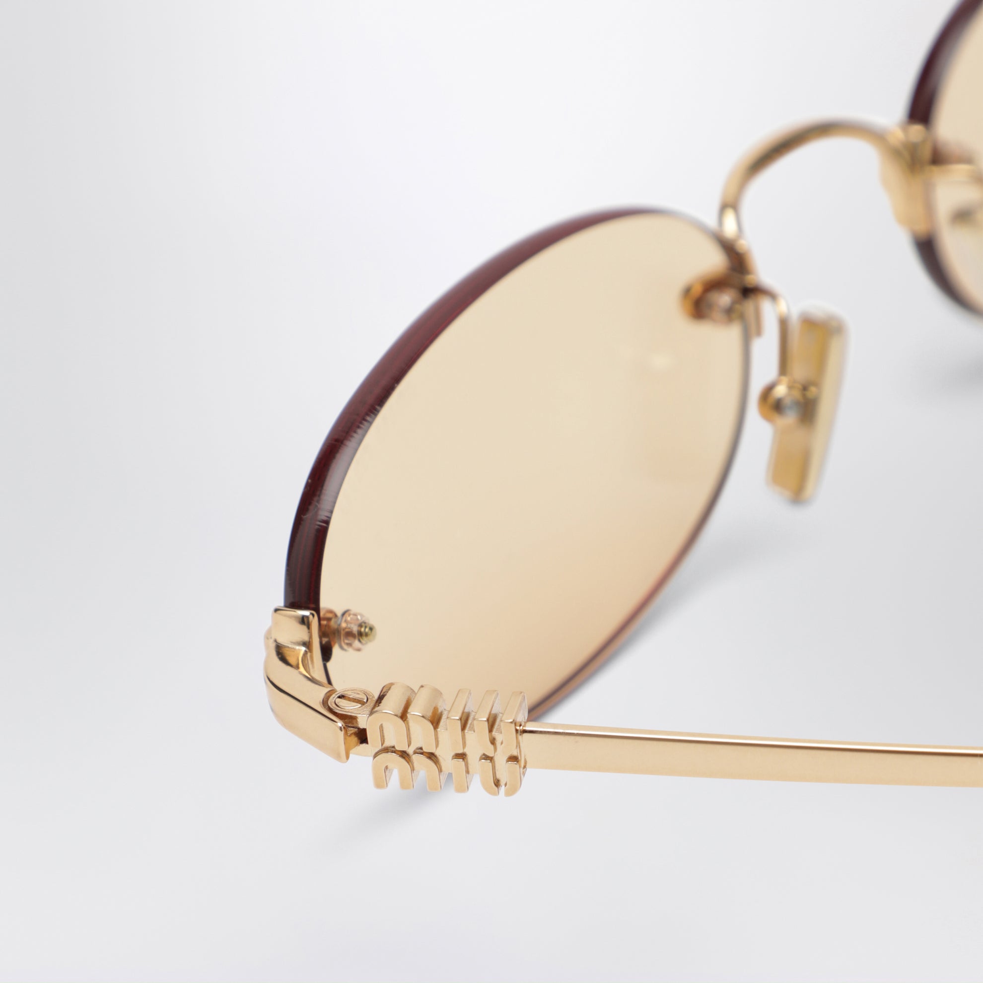 Miu Miu Logo sunglasses in gold/pink