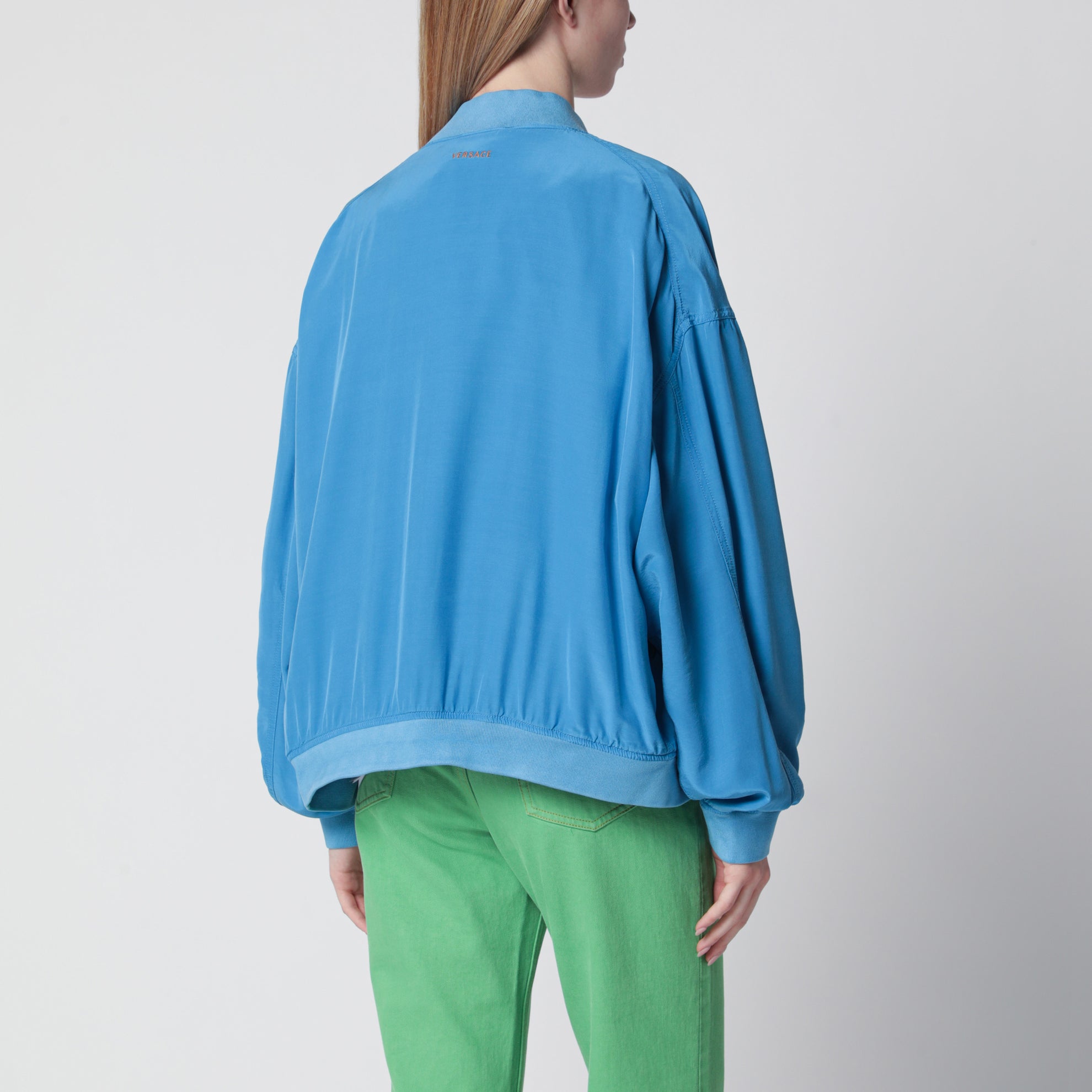Blouson con zip azzurro in popeline di seta