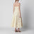Gelbes Midikleid mit floralen Applikationen