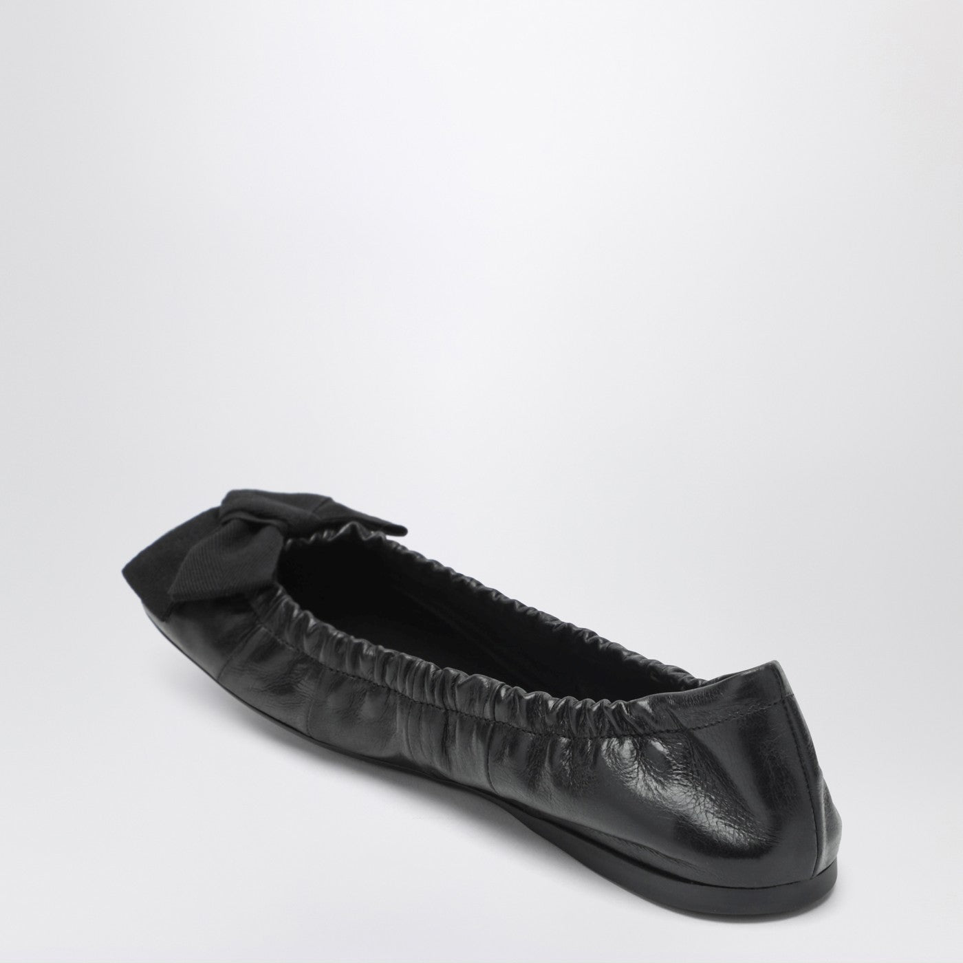 Black patent leather ballet flats with bow