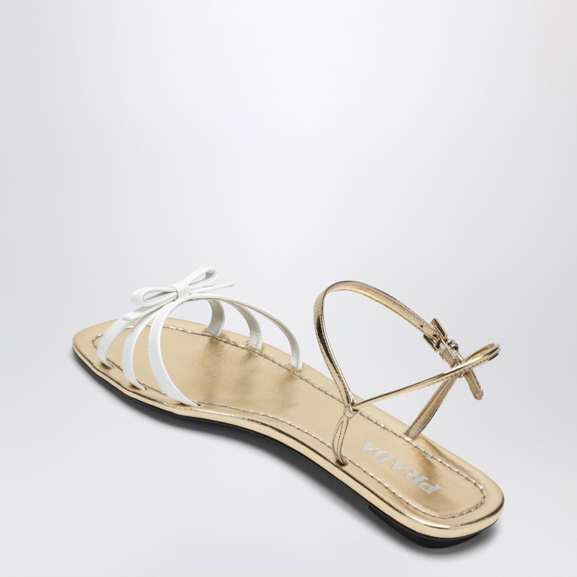 White and gold leather sandals with bow