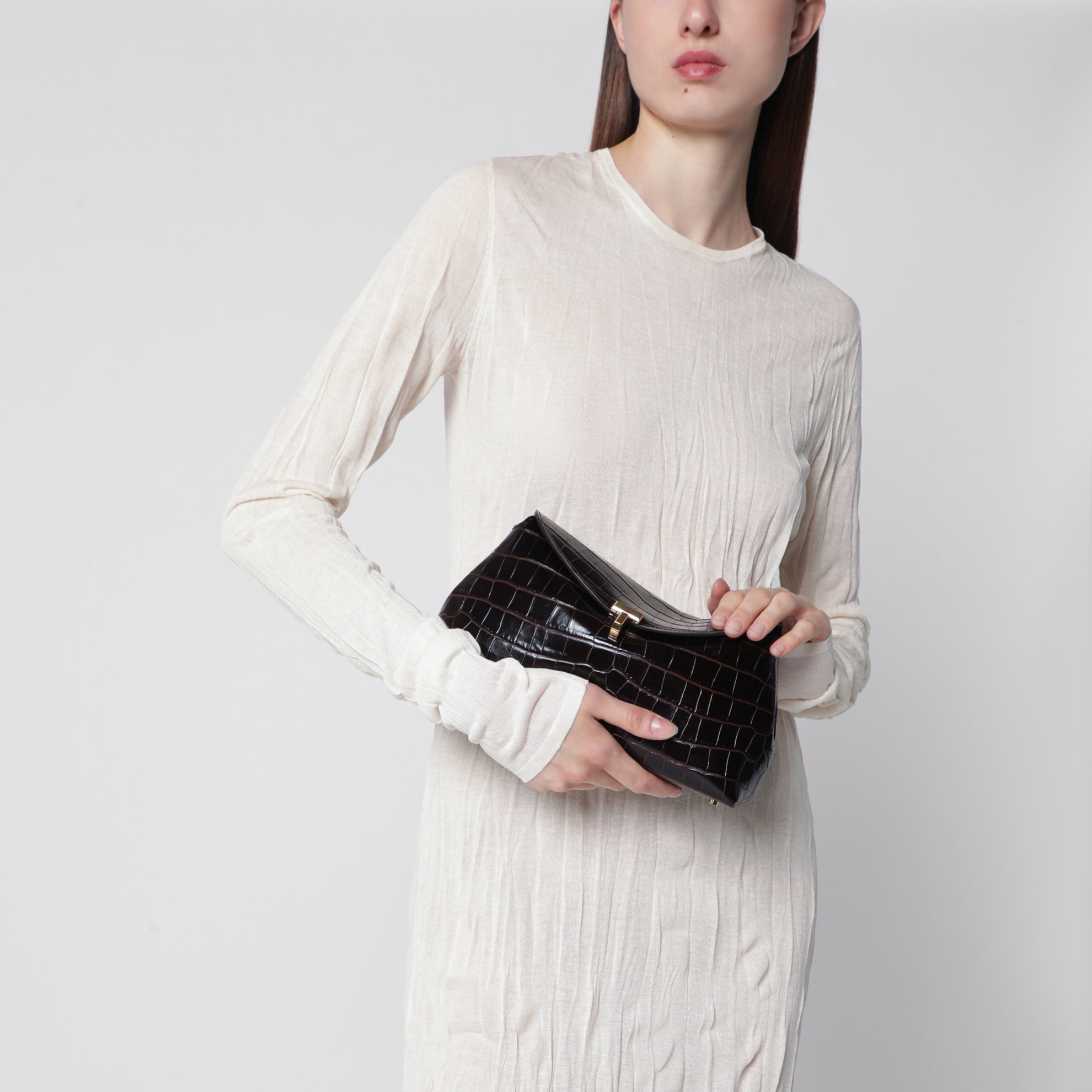 Brown T-lock clutch in crocodile-embossed leather