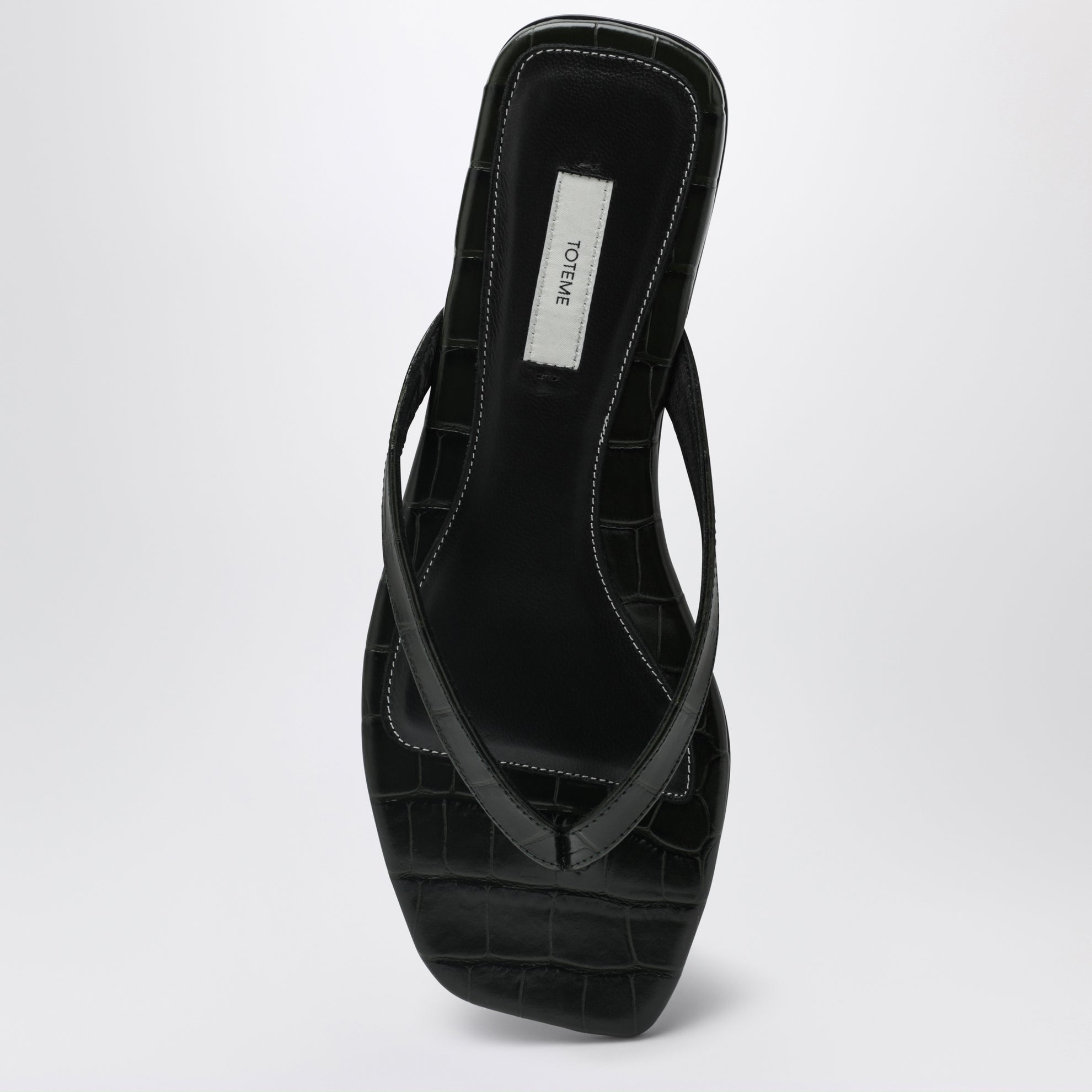 Crocodile-effect leather flip-flops in green