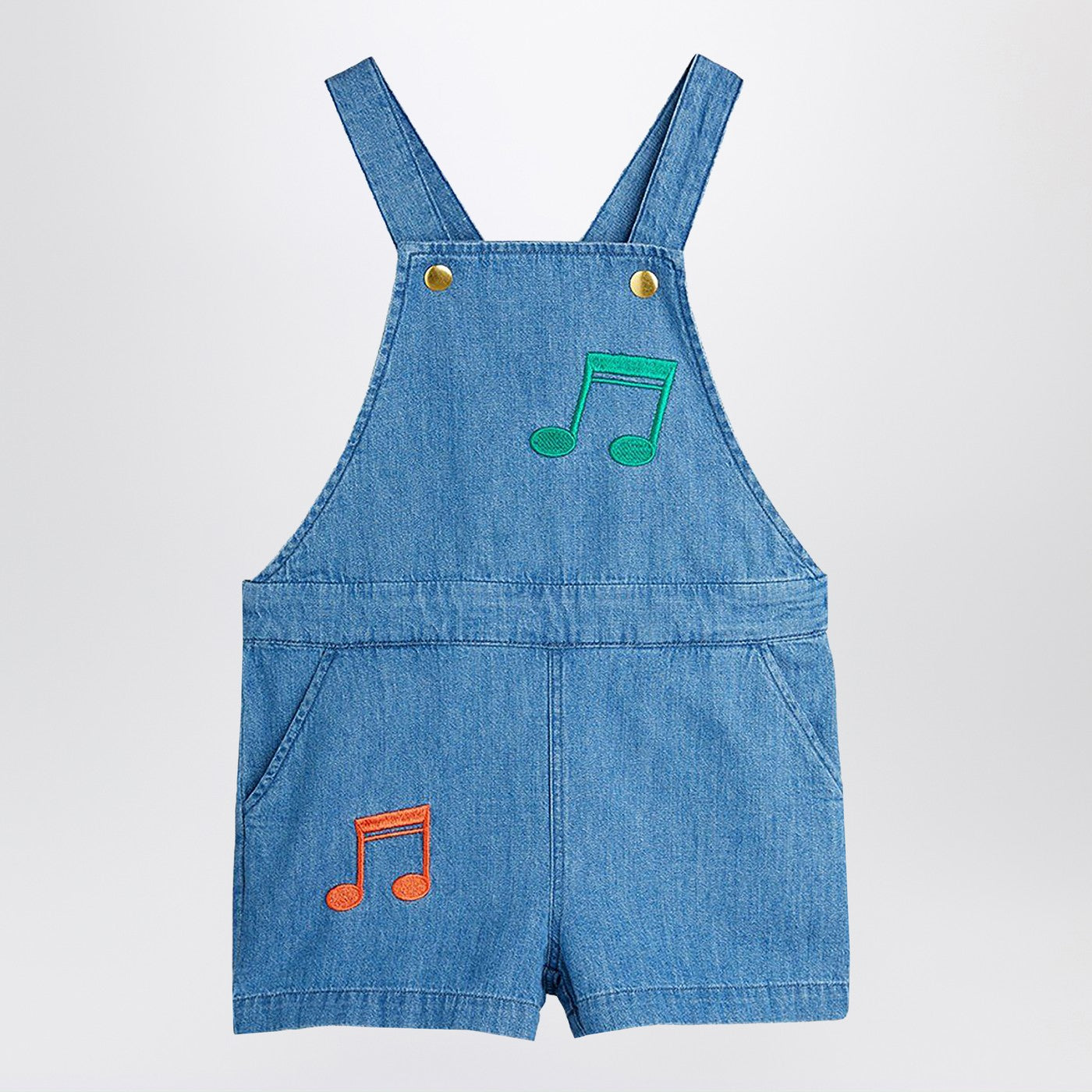 Salopette azzurra in denim con note musicali