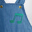 Salopette azzurra in denim con note musicali