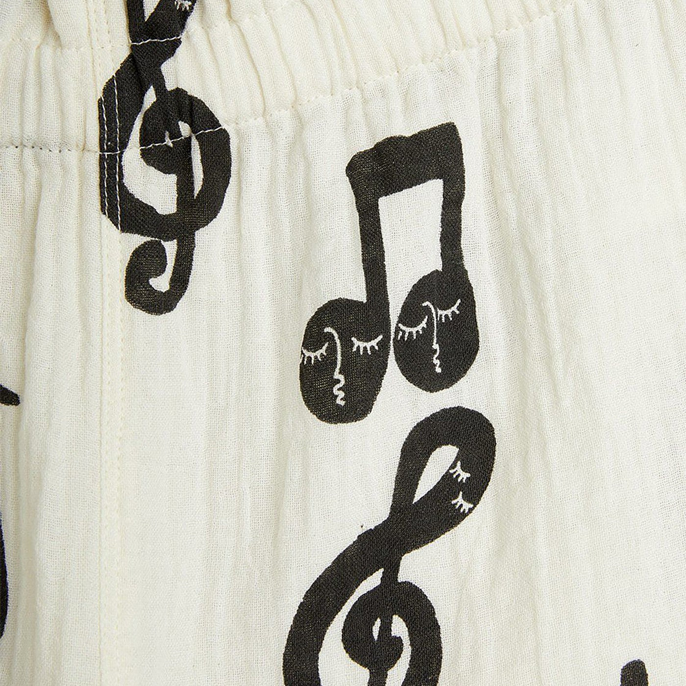 Wide white trousers with musical notes
