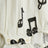 White bodysuit with musical notes