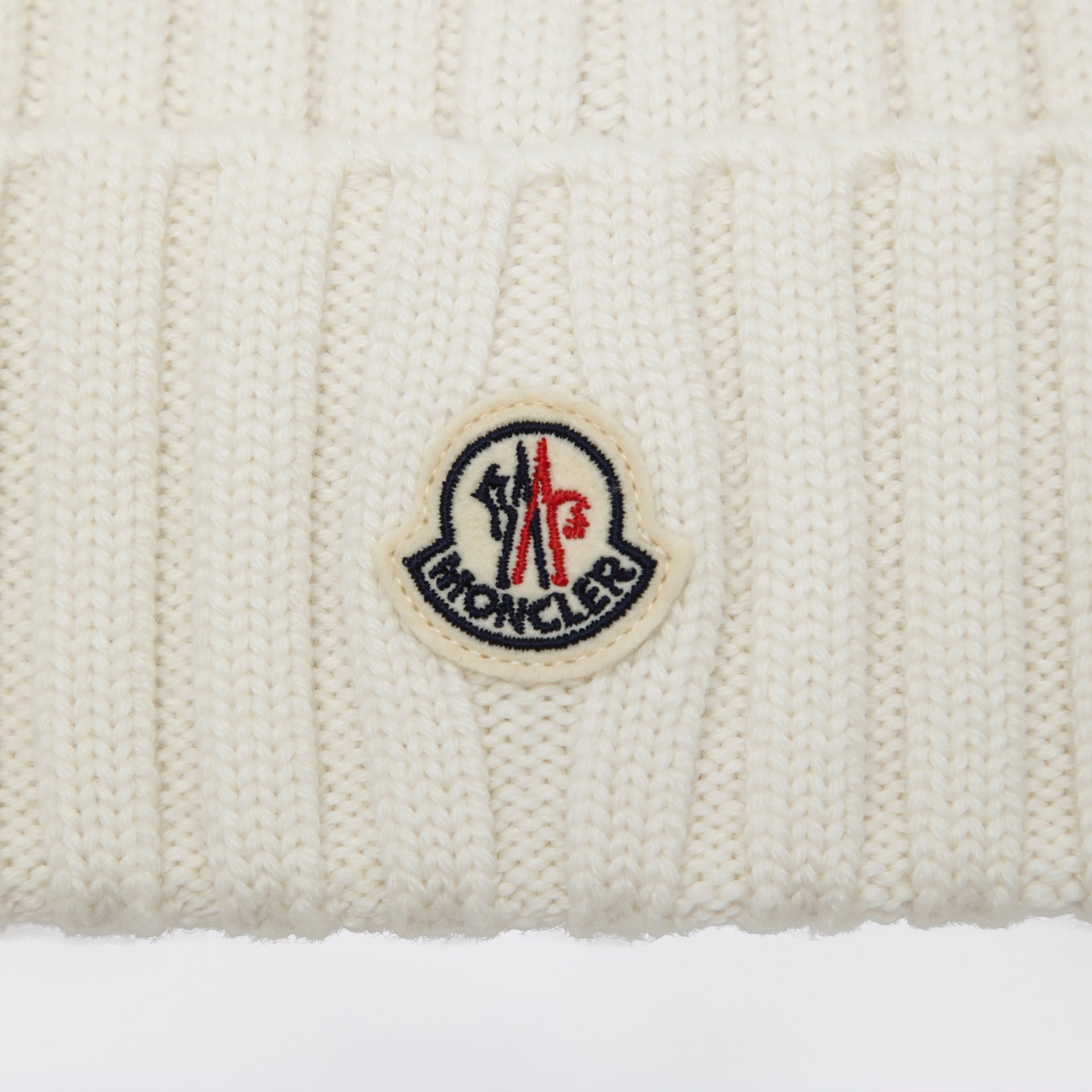 White cable-knit wool beanie with logo
