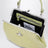 Charm bag in lime croc-effect patent leather