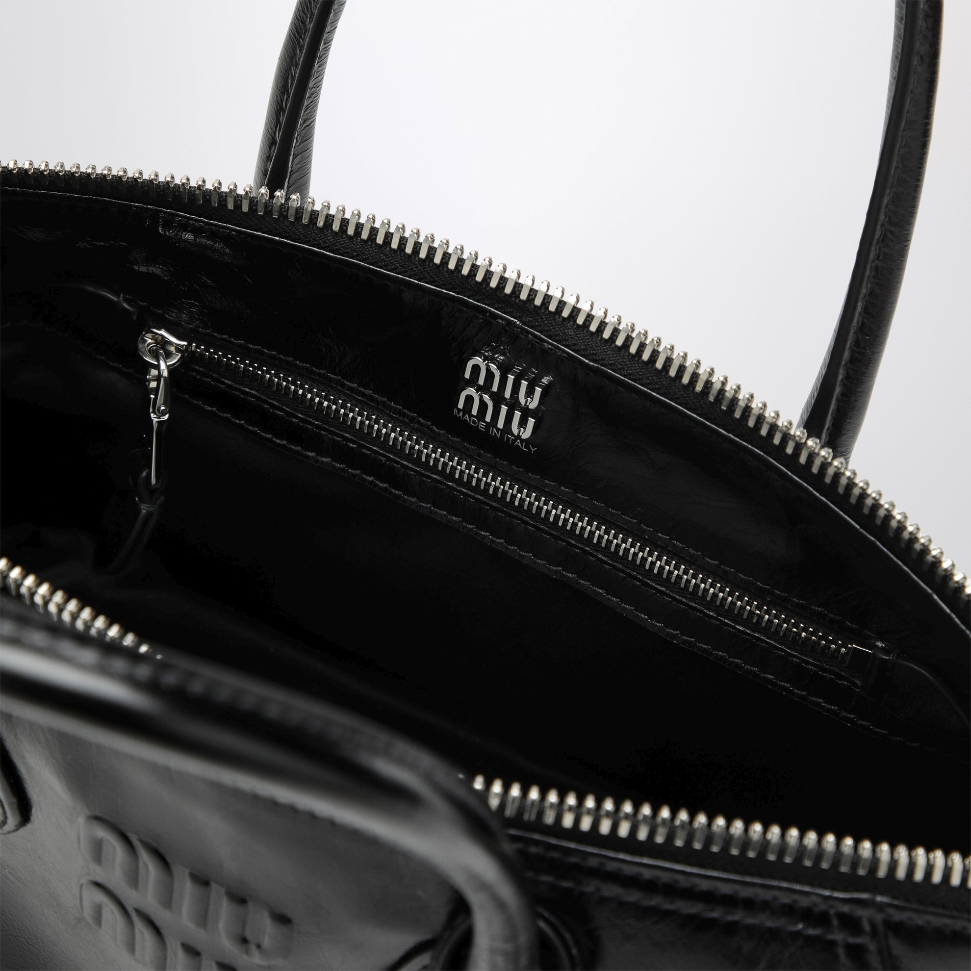 Black glossy leather top-handle bag