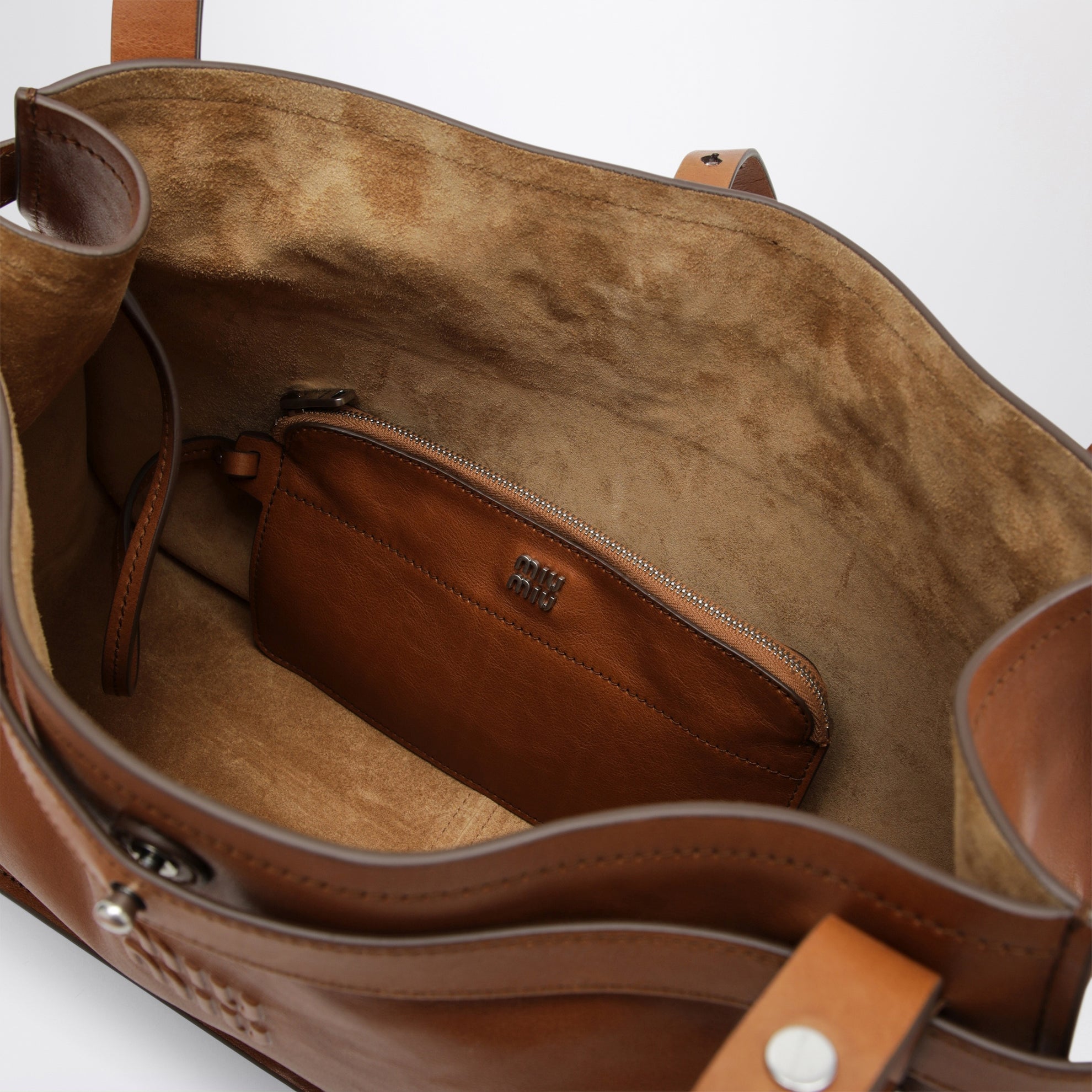 Calfskin crossbody bag with embossed logo in cognac