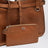 Calfskin crossbody bag with embossed logo in cognac