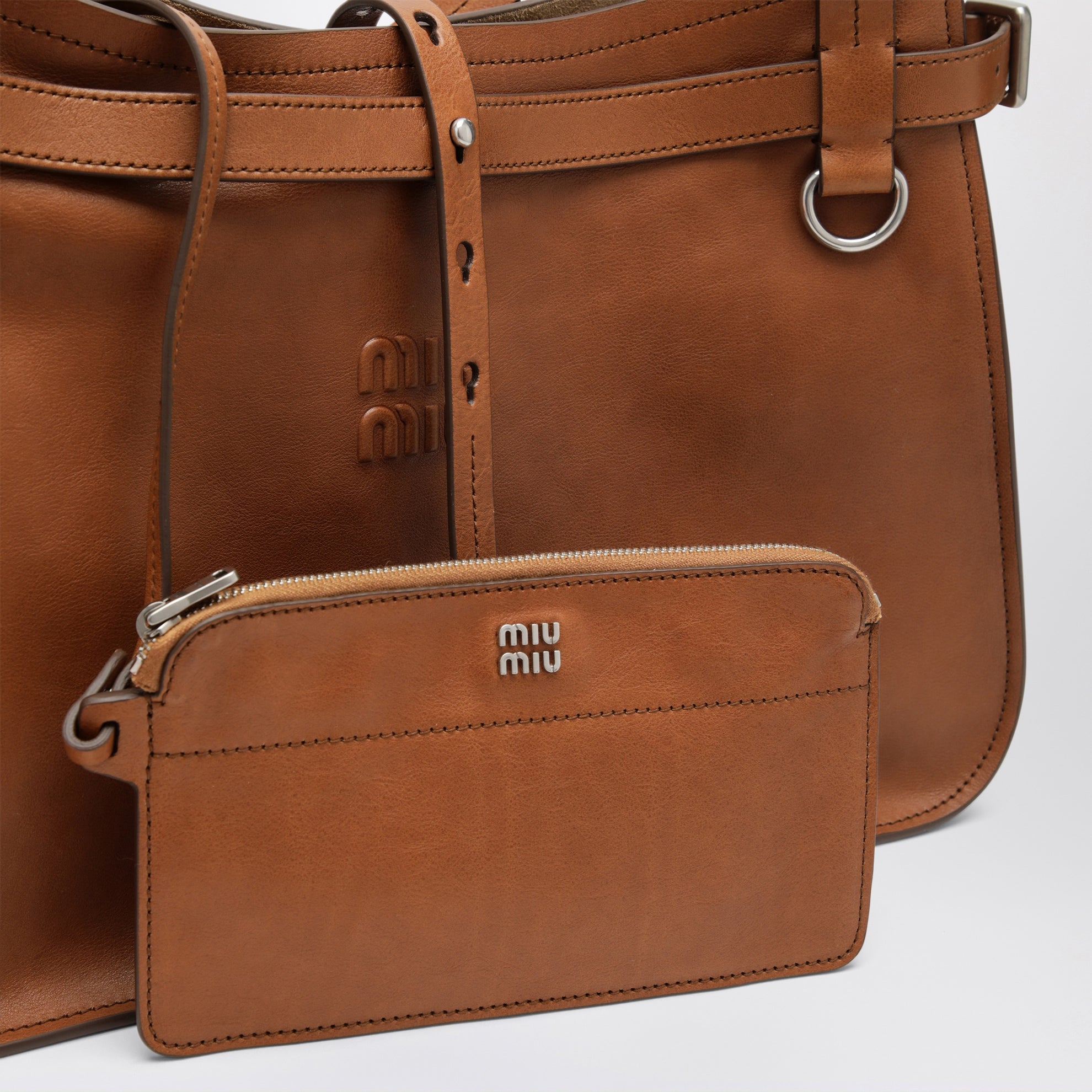 Calfskin crossbody bag with embossed logo in cognac