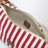 Pochette rayée en coton jacquard et cuir rubis cognac