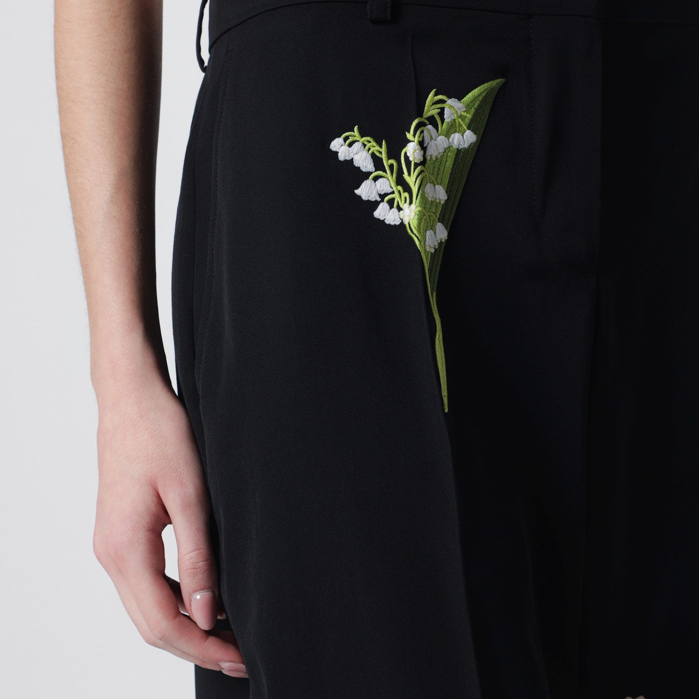 Black wool trousers with floral embroidery