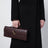 Andiamo clutch bag with handle in Dark Barolo