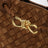 Borsa a mano Andiamo piccola in suede intrecciato color ambra