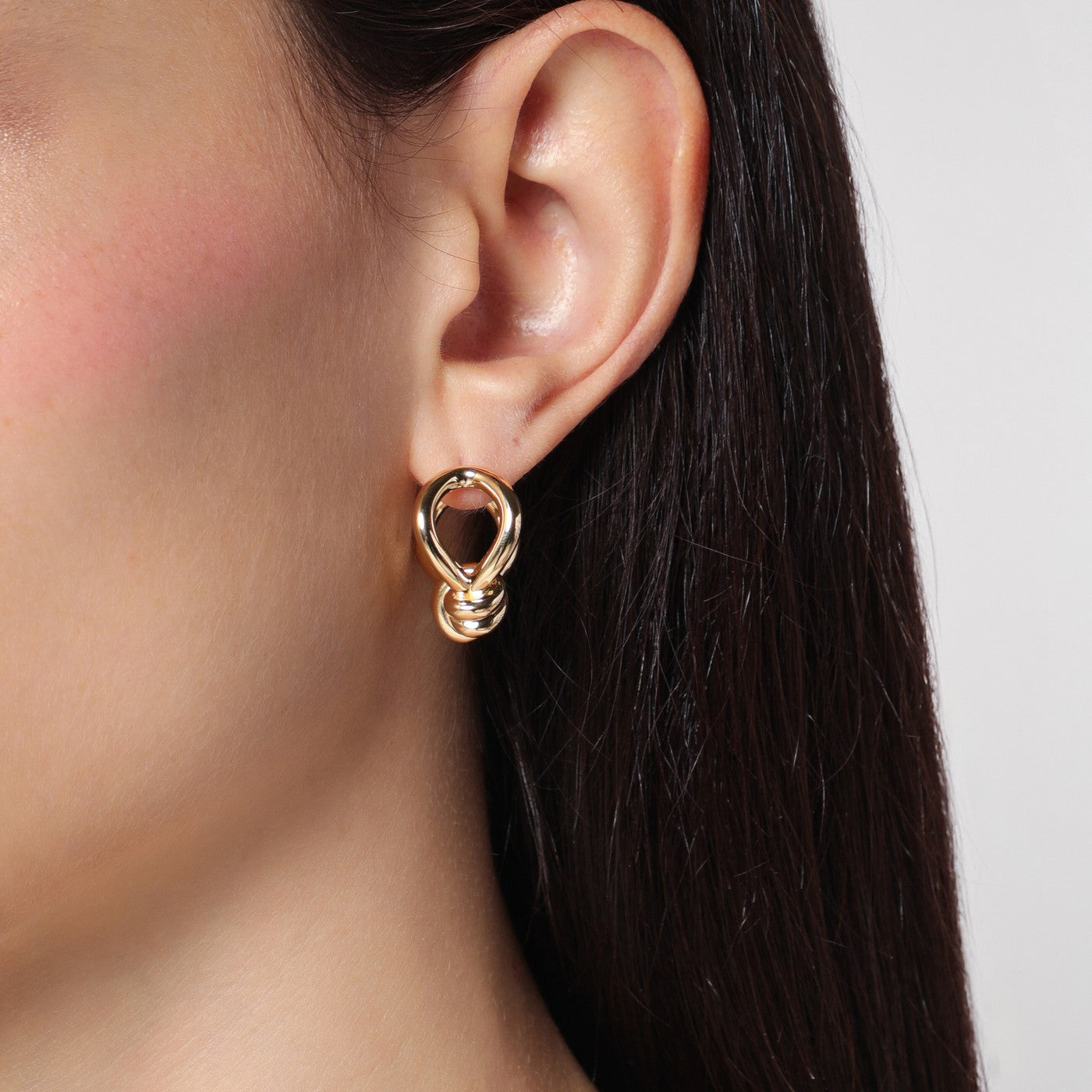Gold earrings with Knot detail.