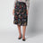 Plissierter Midirock aus Seide mit Flora-Print in Schwarz
