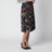 Plissierter Midirock aus Seide mit Flora-Print in Schwarz
