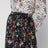 Plissierter Midirock aus Seide mit Flora-Print in Schwarz