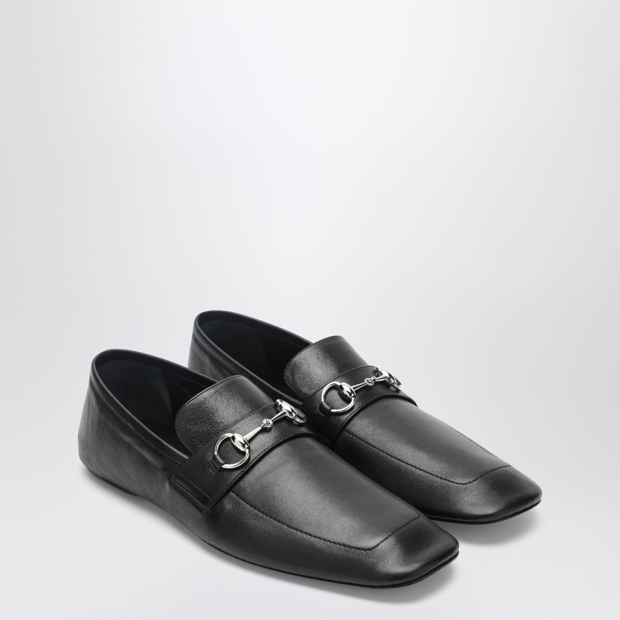 Black leather horsebit loafers with silver hardware