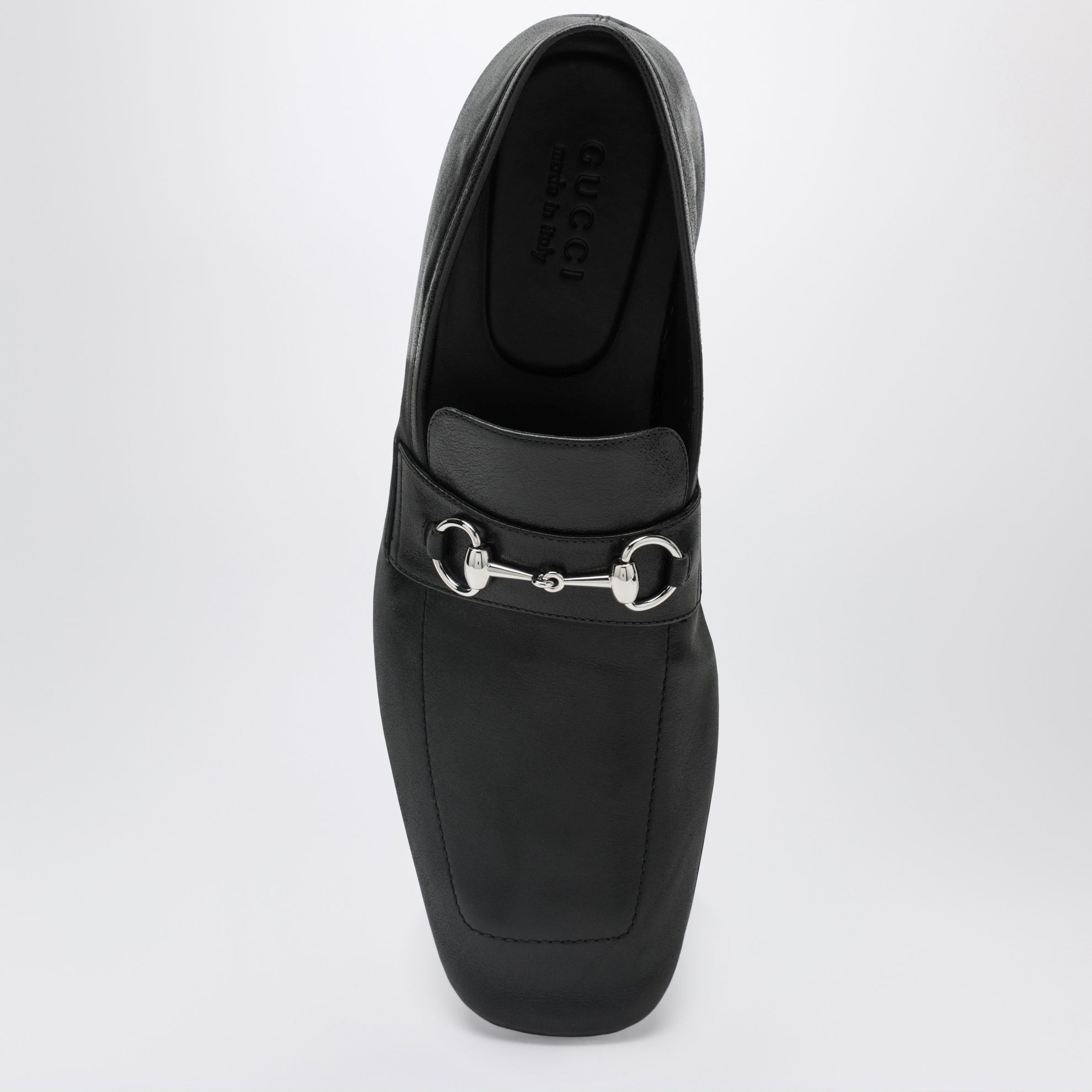 Black leather horsebit loafers with silver hardware