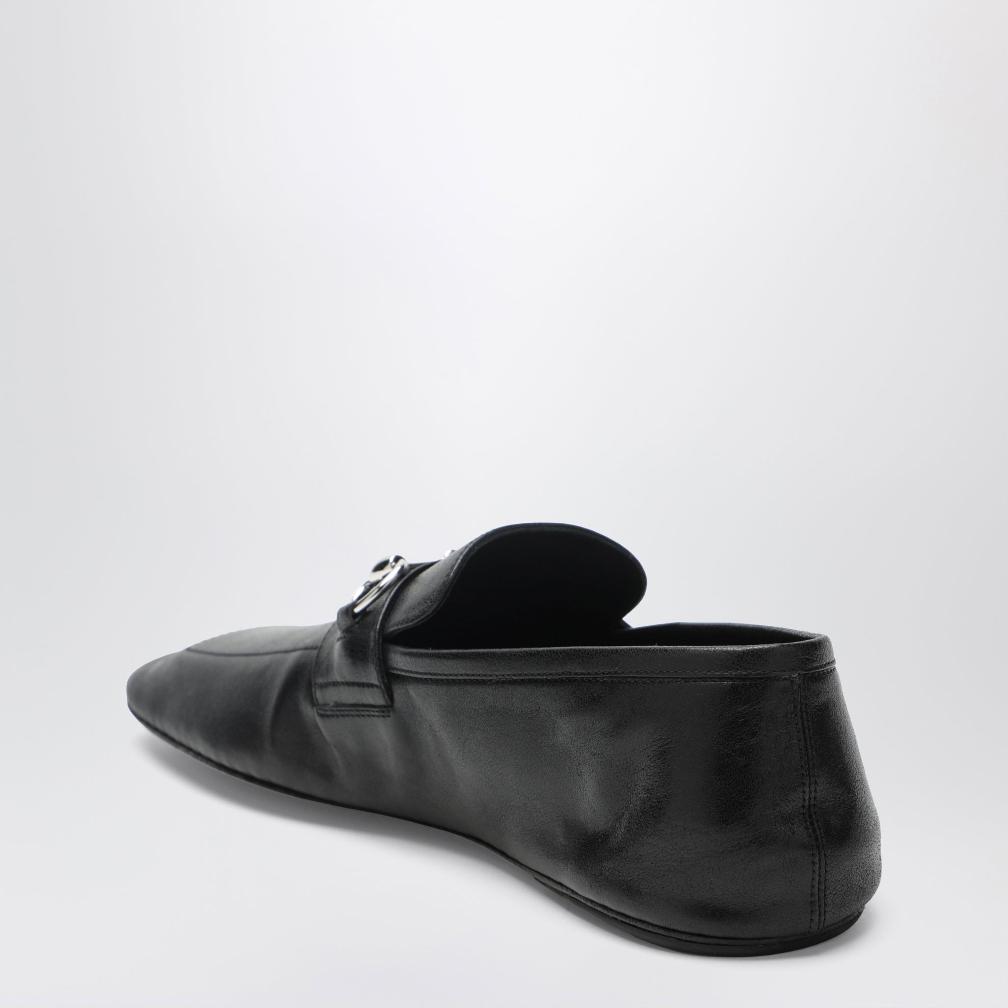 Black leather horsebit loafers with silver hardware