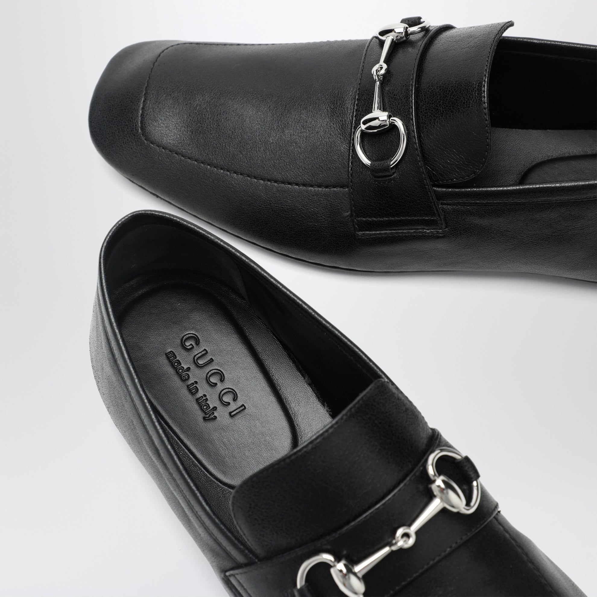 Black leather horsebit loafers with silver hardware