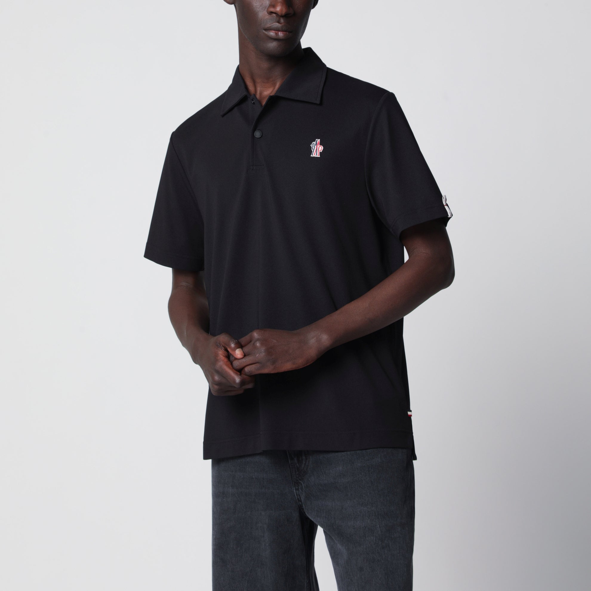Black polo shirt with logo patch