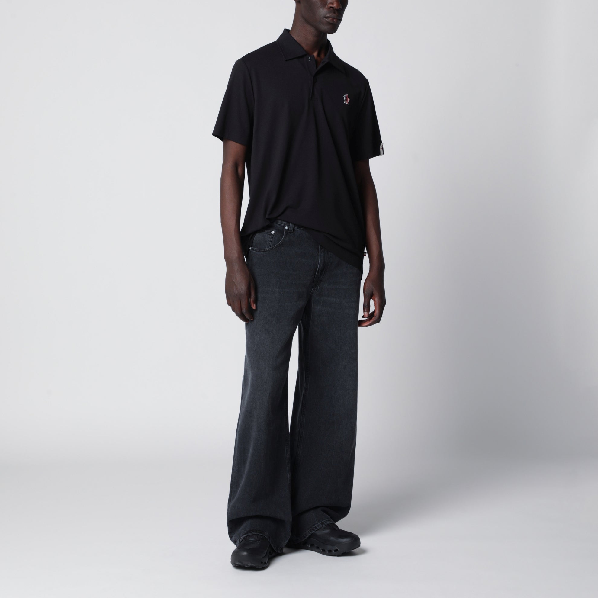 Black polo shirt with logo patch