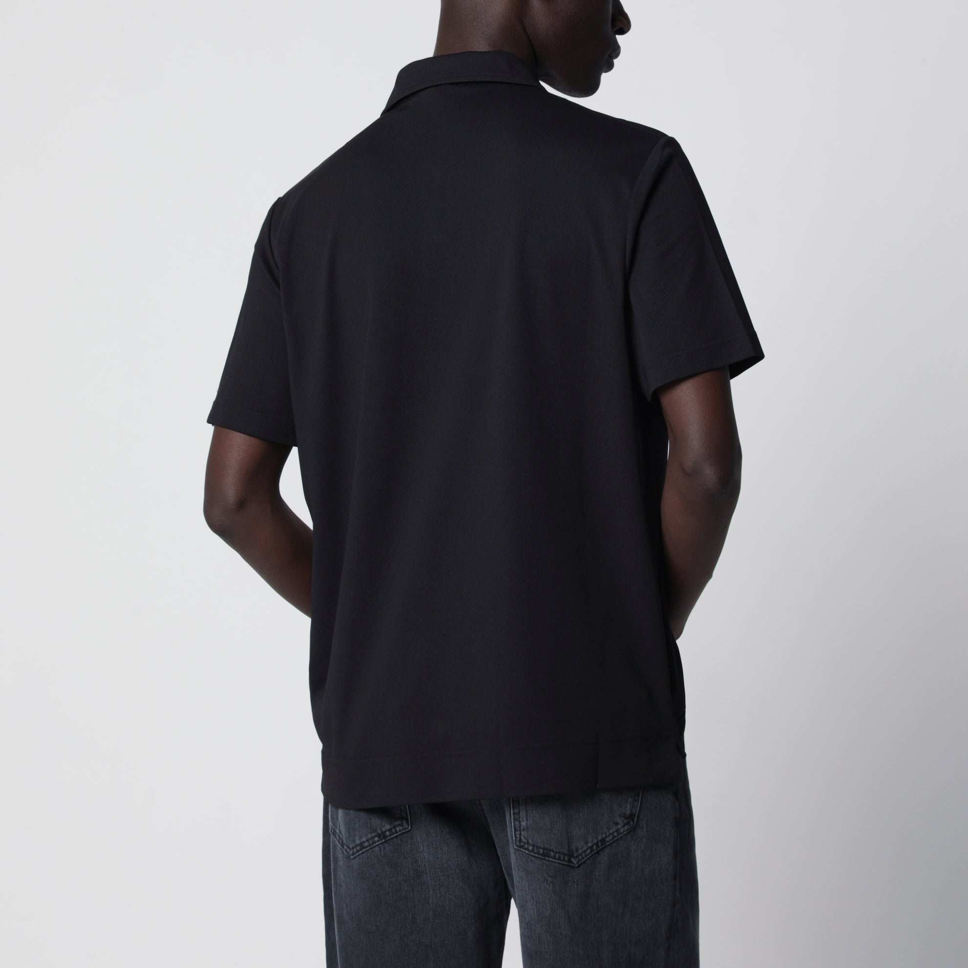 Black polo shirt with logo patch