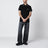 Polo nera in cotone con patch logo