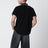 Polo nera in cotone con patch logo