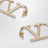 Boucles d’oreilles VLogo Signature en métal doré