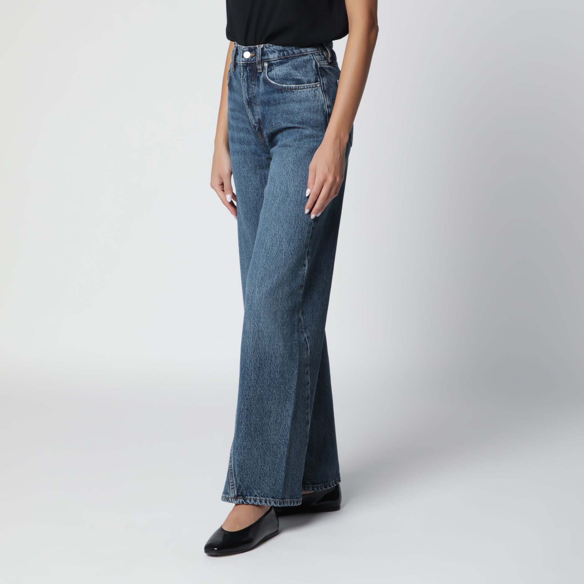 Washed blue jeans with curved front seams