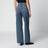 Washed blue jeans with curved front seams