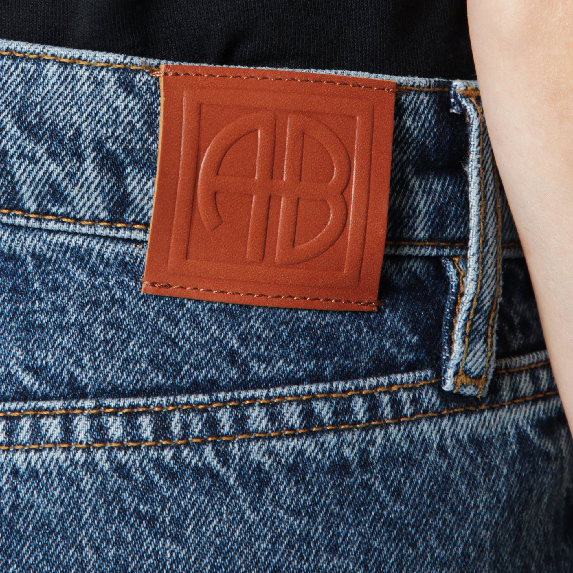 Washed blue jeans with curved front seams
