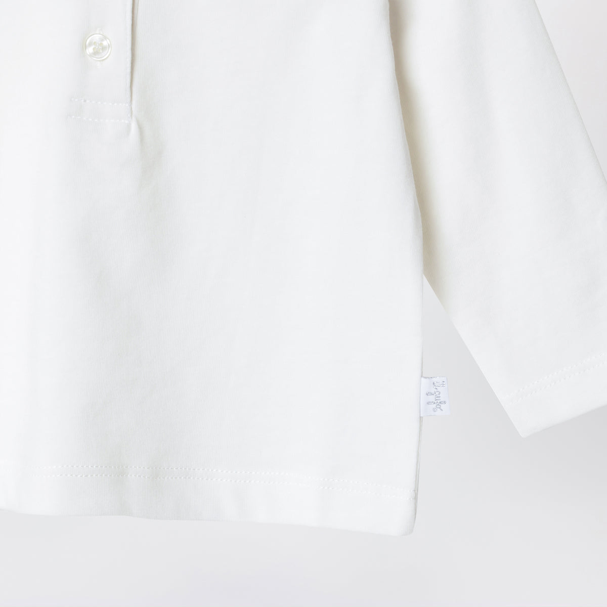 Polo bianco latte in cotone con colletto volant