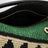 Kleine Puzzle Edge Tasche aus Raffia und Kalbsleder in Schwarz/Grün