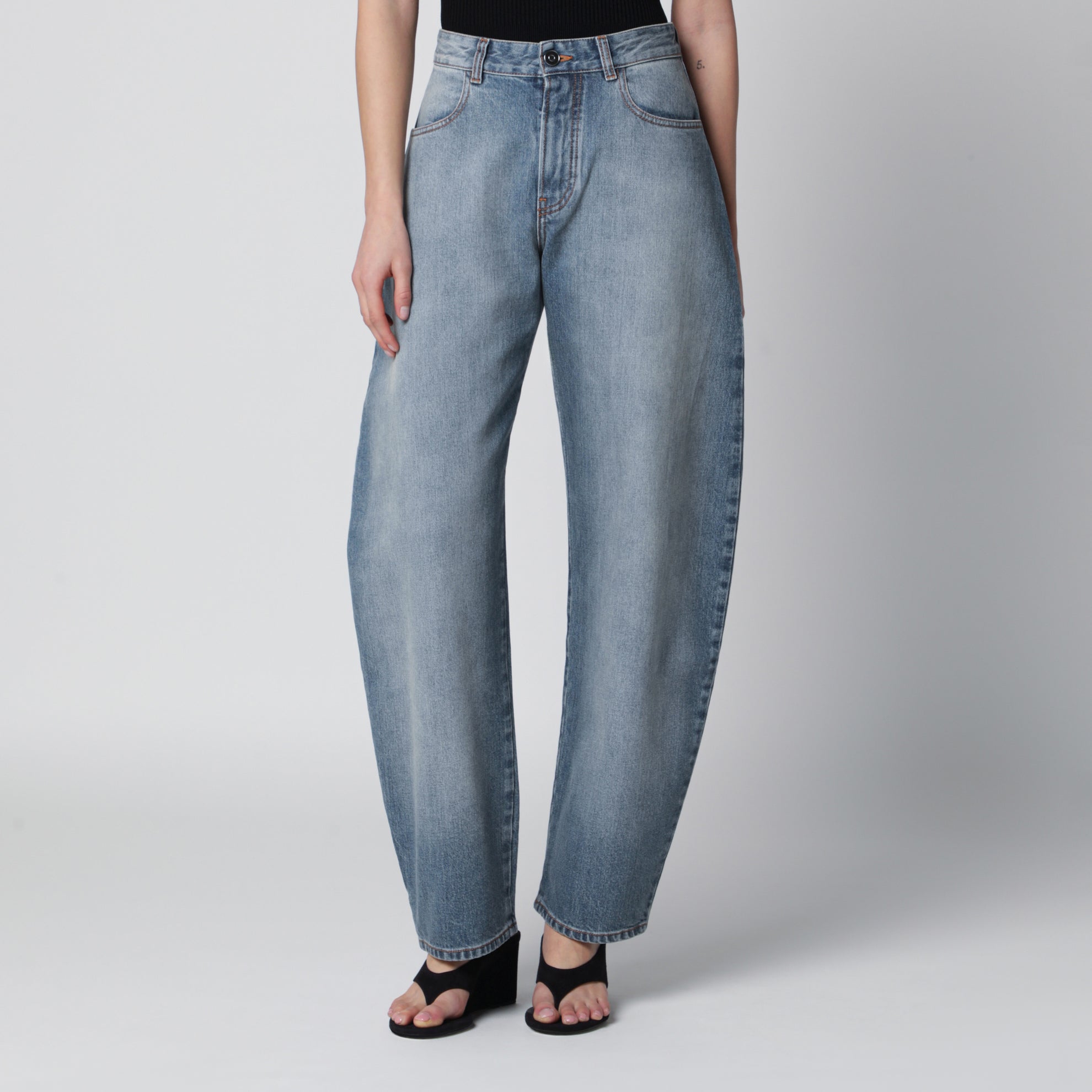 Low-rise curved-leg raw denim jeans in blue