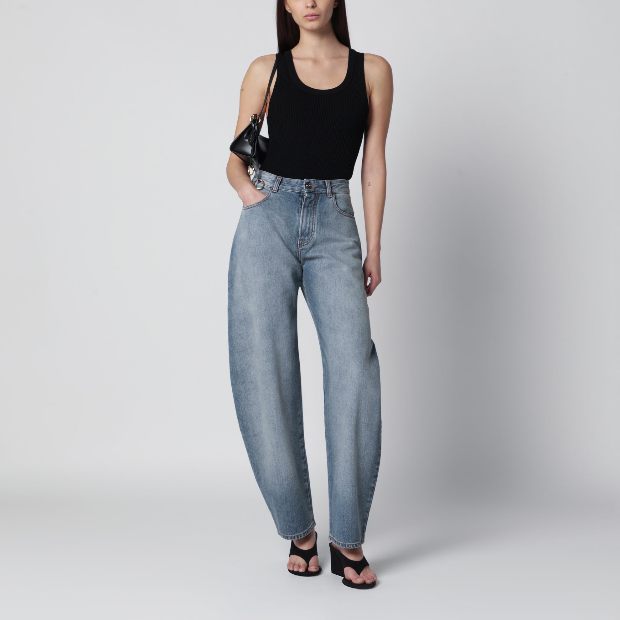 Low-rise curved-leg raw denim jeans in blue