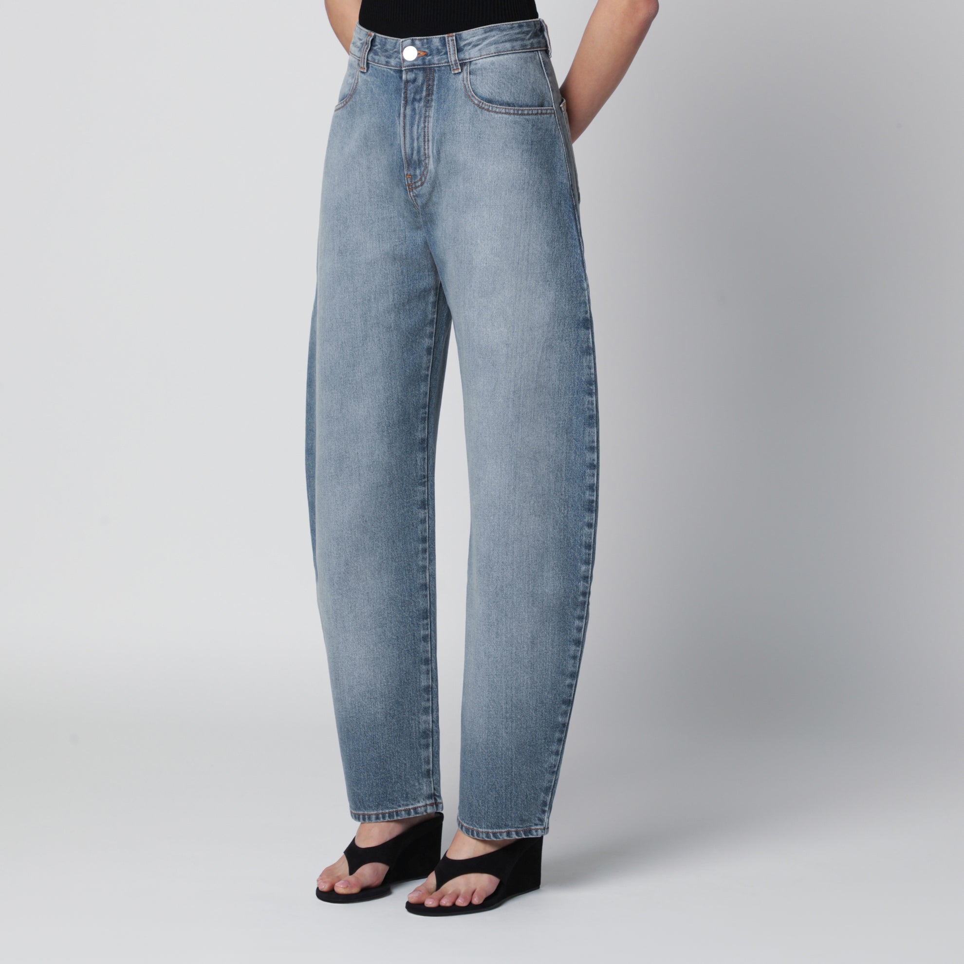 Low-rise curved-leg raw denim jeans in blue