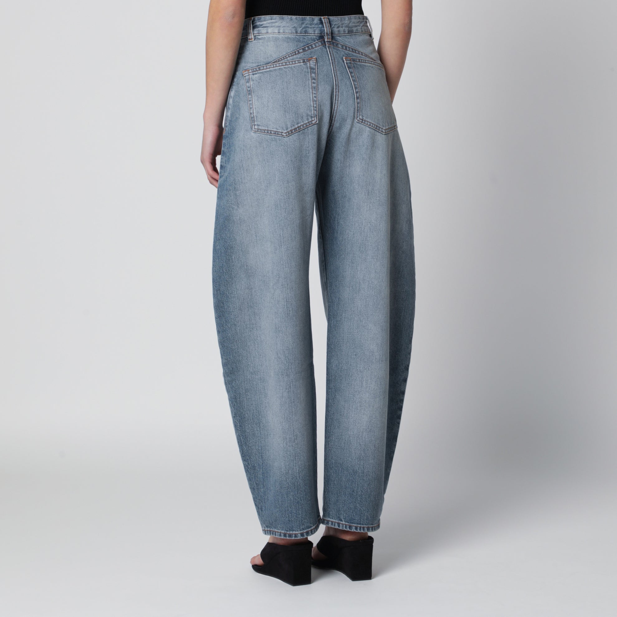 Low-rise curved-leg raw denim jeans in blue