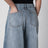 Low-rise curved-leg raw denim jeans in blue