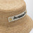 Cappello bucket in rafia con logo