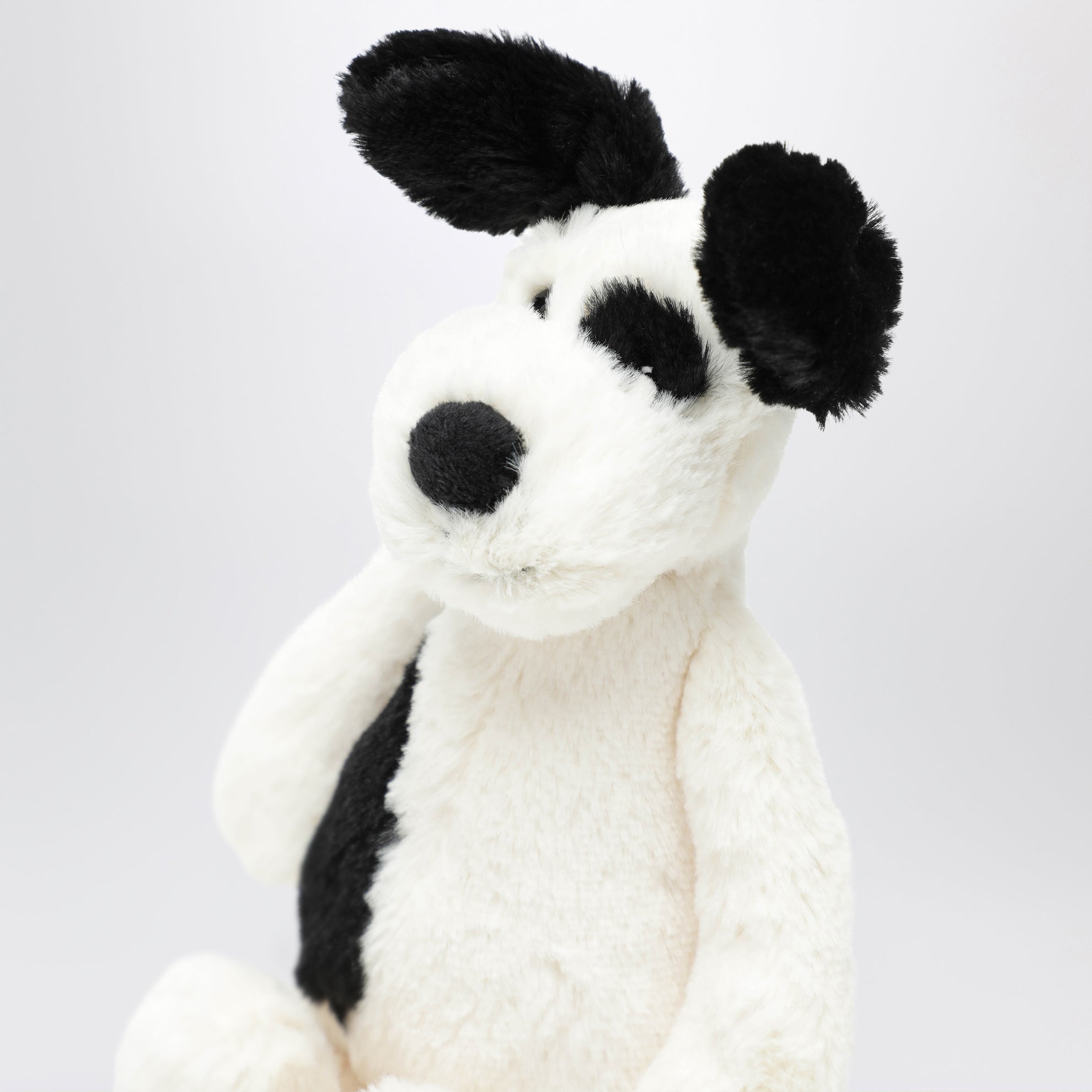 Peluche a forma di cagnolino bianco/nero
